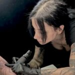 missizlecter with her hand on her chin